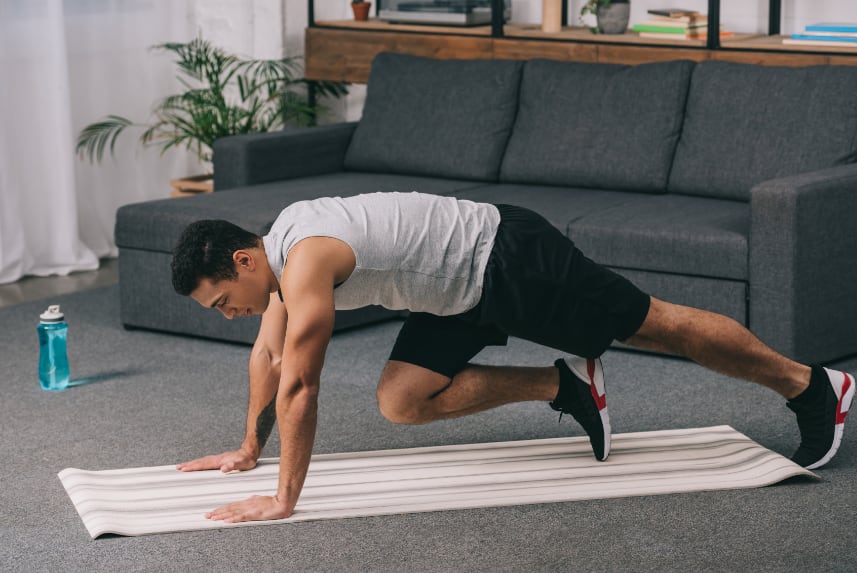 Man doing cardio in an apartment living room.